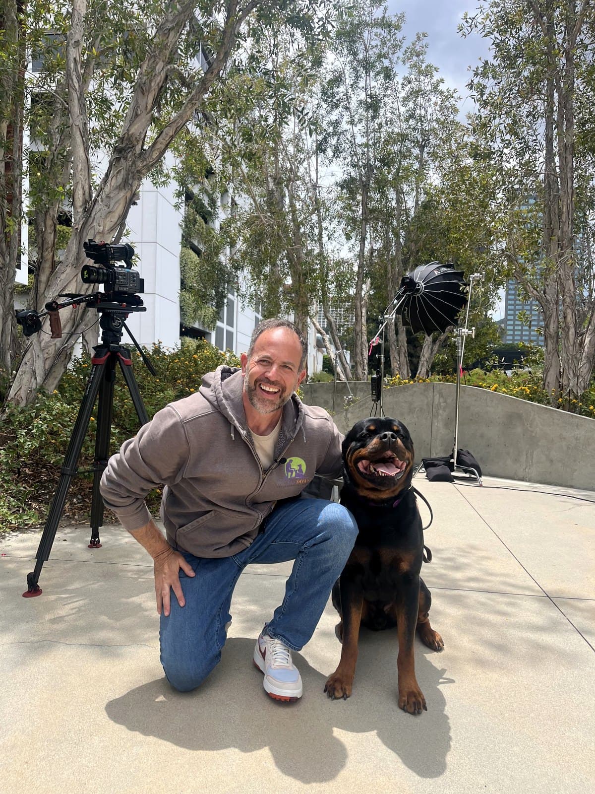 Brett Endes laughing with a relaxed Rottweiler